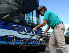 Pull up the release on the bike rack at the front of the bus